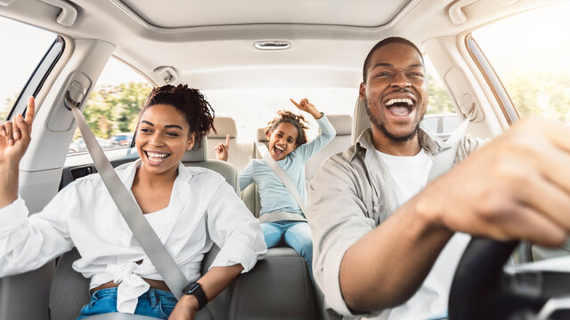 Wall Mural - Happy Black Family Of Three Singing Having Fun Riding Car