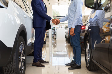 Wall Mural - Cropped Image Of Car Seller Shaking Hands With Client After Successful Deal