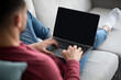 © Prostock-studio - Arab guy using laptop with empty screen at home