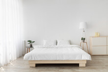 Ideas For Scandinavian Minimalist Bedroom. Double Bed With Pillows, Soft White Blanket, Lamp And Furniture
