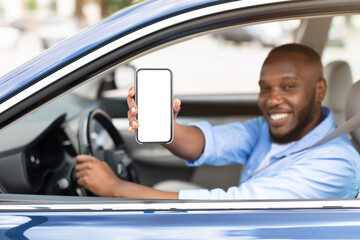 happy black driver using showing smartphone with empty screen