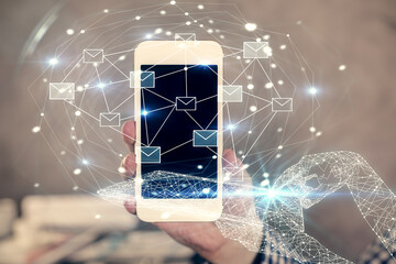 Poster - Double exposure of man's hands holding and using a digital device and envelop hologram drawing. E-mail concept.