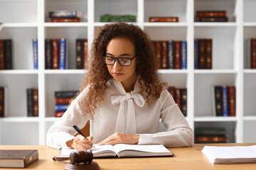 Wall Mural - Female judge working at table in courtroom