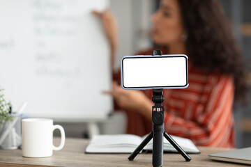 Poster - Teacher recording video, selective focus on blank gadget screen