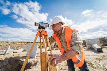 Wall Mural - Surveyor worker with theodolite equipment at construction site