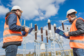 Two engineer electricians check the substation construction process