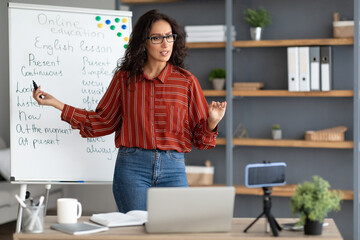 Wall Mural - English teacher pointing on board, giving virtual lesson to students