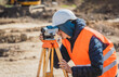 © romaset - Surveyor worker with theodolite equipment at construction site
