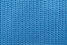 Knitted Fabric. Blue Knitted Rug Close-up. Textile Texture On A Blue Background. Detailed Warm Yarn Background. Knit Cashmere Wool. Natural Woolen Fabric, A Fragment Of A Sweater. Knitting Pattern