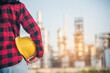 Woman worker hands holding hardhat yellow work helmet Construction Engineer. Refinery woman worker oil petro industry hand hold yellow worker helmet hard hat. Refinery industry engineer manufacture