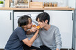 Asian handsome man gay family sitting on floor, eating pizza together. 