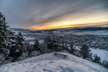 Wall Mural - Cold snowy winter morning. Beautiful sunrise over village Liskova in Slovakia