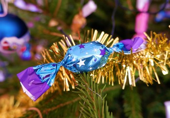 traditional Hungarian Christmas candy named szaloncukor in bright colorful packaging on the christmas tree