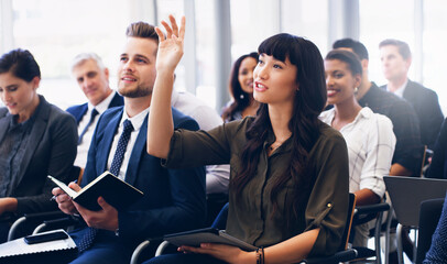 Poster - Cropped shot of an attractive young businesswoman sitting with her diverse colleagues and raising her hand while in the office