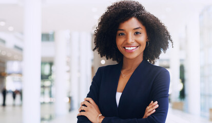 Aufkleber - Cropped portrait of an attractive young businesswoman smiling and standing in the office with her arms crossed during the day