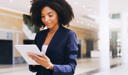 Aufkleber - Cropped shot of an attractive young businesswoman standing alone and using a tablet while in the office during the day