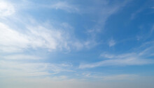 Clear Blue Sky With White Fluffy Clouds At Noon. Day Time. Abstract Nature Landscape Background.
