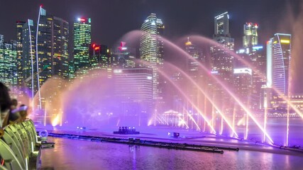 Wall Mural - Light and Water Show along promenade in front of Marina Bay Sands timelapse