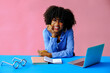 © Carlos David - cheerful young african american black entrepreneur student businesswoman leaning on hand and smiling at camera at workplace
