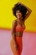 © Carlos David - happy athletic african american woman in sportswear posing in studio
