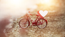 Bike Is Parked And There Is A Heart Shape On Top. Concept Of Love Of Lovers On Valentine's Day, Red Bicycle Love