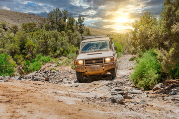 off roading with an all terrain vehicle through a dry riverbed in the arkaroola wilderness sanctuary