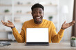 © Prostock-studio - Emotional black guy using laptop with empty screen