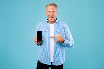 Poster - Excited mature man pointing finger at empty smartphone screen