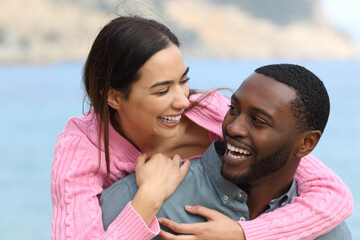 Wall Mural - Happy couple joking and laughing on the beach