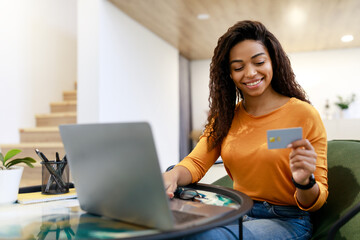Poster - Happy woman holding debit credit card, using pc