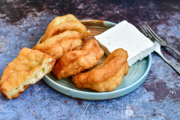 Wall Mural - Traditional Bulgarian home made deep fried  patties  covered with sugar  оn rustic backgroud.Mekitsa or Mekica,  on wooden  rustic  background. Made of kneaded dough that is deep fried 