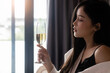 Beauty asian woman with glass of champagne at hotel 