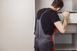 © vladdeep - Furniture assembler installing drawers in wardrobe