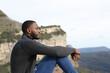 © PheelingsMedia - Man with black skin contemplating sitting in the mountain