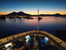 Ship Entering The Port Of Naples Seen From The Bow At Dawn. Port Of Naples While The Sun Rises.
