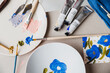 © ADDICTIVE STOCK - Painted plate near colorful paints