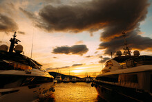 Yachts Moored In Porto Montenegro Against The Backdrop Of An Orange Sunset