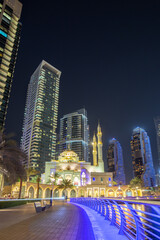 Wall Mural - Mosque at Dubai Marina skyline architecture wealth luxury travel at night portrait format in United Arab Emirates