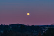 The Moon rising up over the belt of venus looking over the Cumbrian town of Penrith