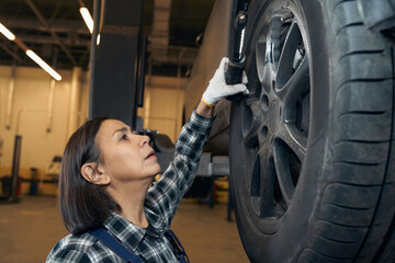 Wall Mural - Concentrated woman working hard at a repair shop