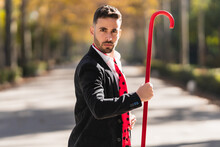 Man In A Suit Holding A Red Stick While Dancing Flamenco Outdoors
