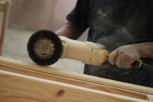 Worker Polishing Wood With Machine