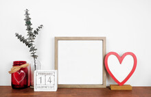 Mock Up Wood Frame With Valentines Day Heart Decor And Calendar. Wood Shelf Against A White Wall. Copy Space.