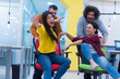 © as-artmedia - Young business people ride chairs in the office