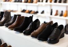 Woman Shoes Diversity At Shelves Of Apparel Shop