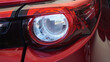 Red sports car tail lights Modern design provides light for safe driving, preventing accidents in traveling as a close-up view.