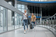 © zinkevych - Two agitated passengers rushing through the airport terminal