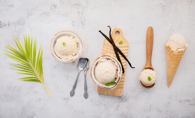Fototapete - Coconut ice cream flavours in half of coconut setup on white stone background. Summer and Sweet menu concept.