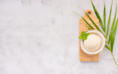 Fototapete - Coconut ice cream flavours in half of coconut setup on white stone background. Summer and Sweet menu concept.