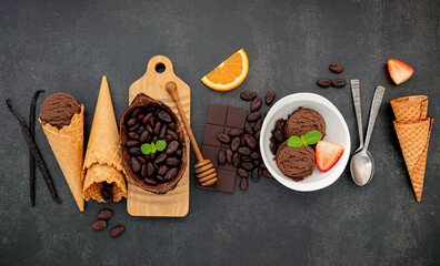Fototapete - Chocolate ice cream flavours in bowl with dark chocolate and cacao nibs setup on dark stone background .